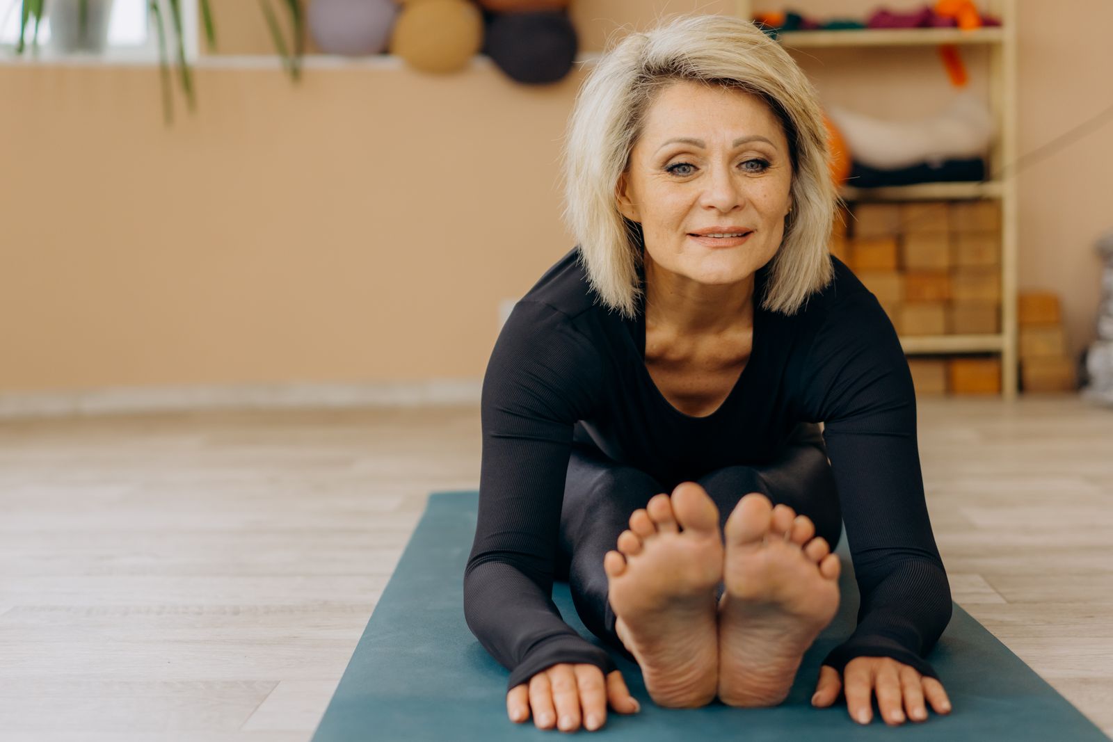 Mature woman in a low-impact fitness class focusing on gentle, joint-friendly movement