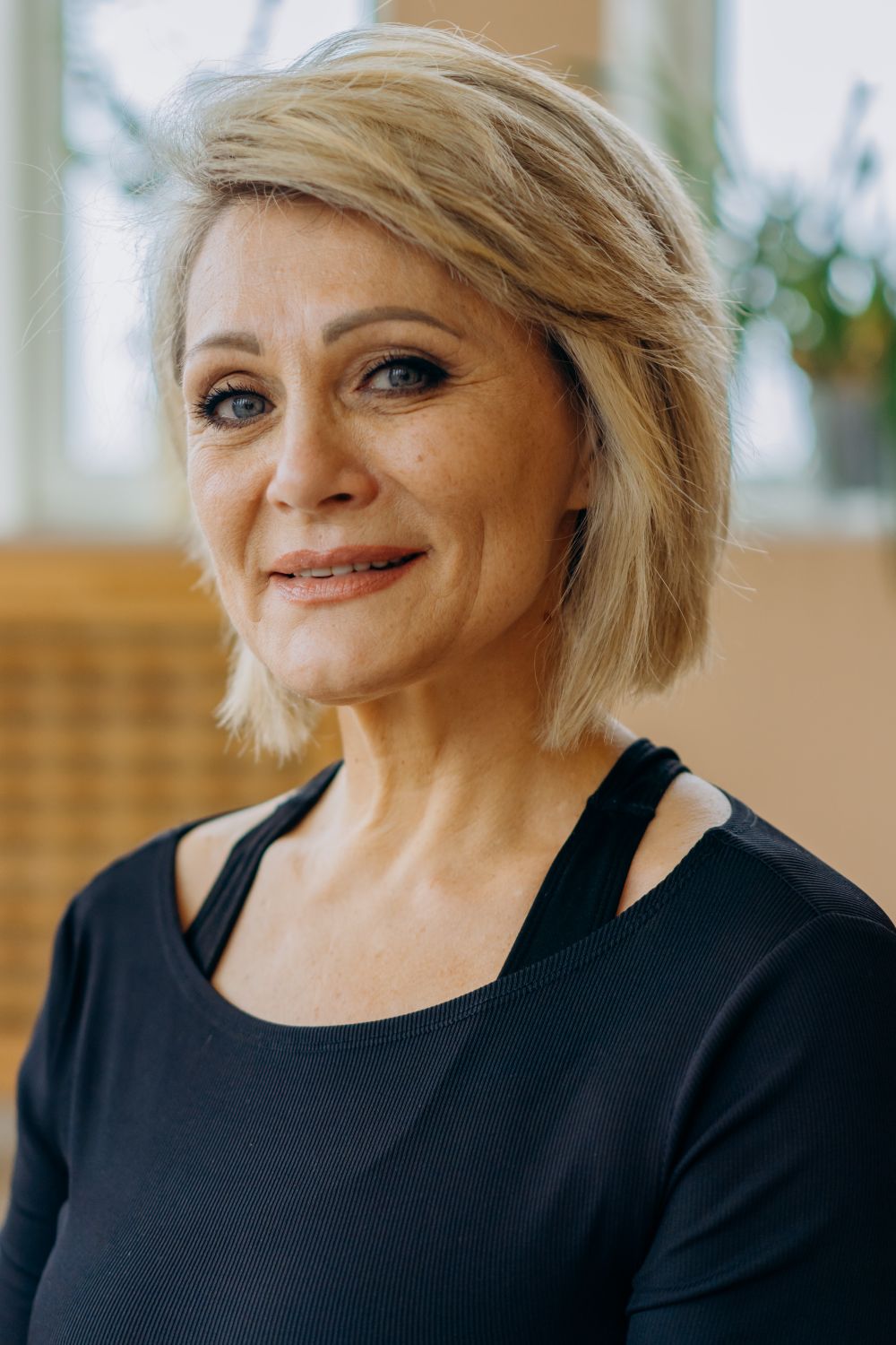 A smiling grandmother in a softly lit home setting