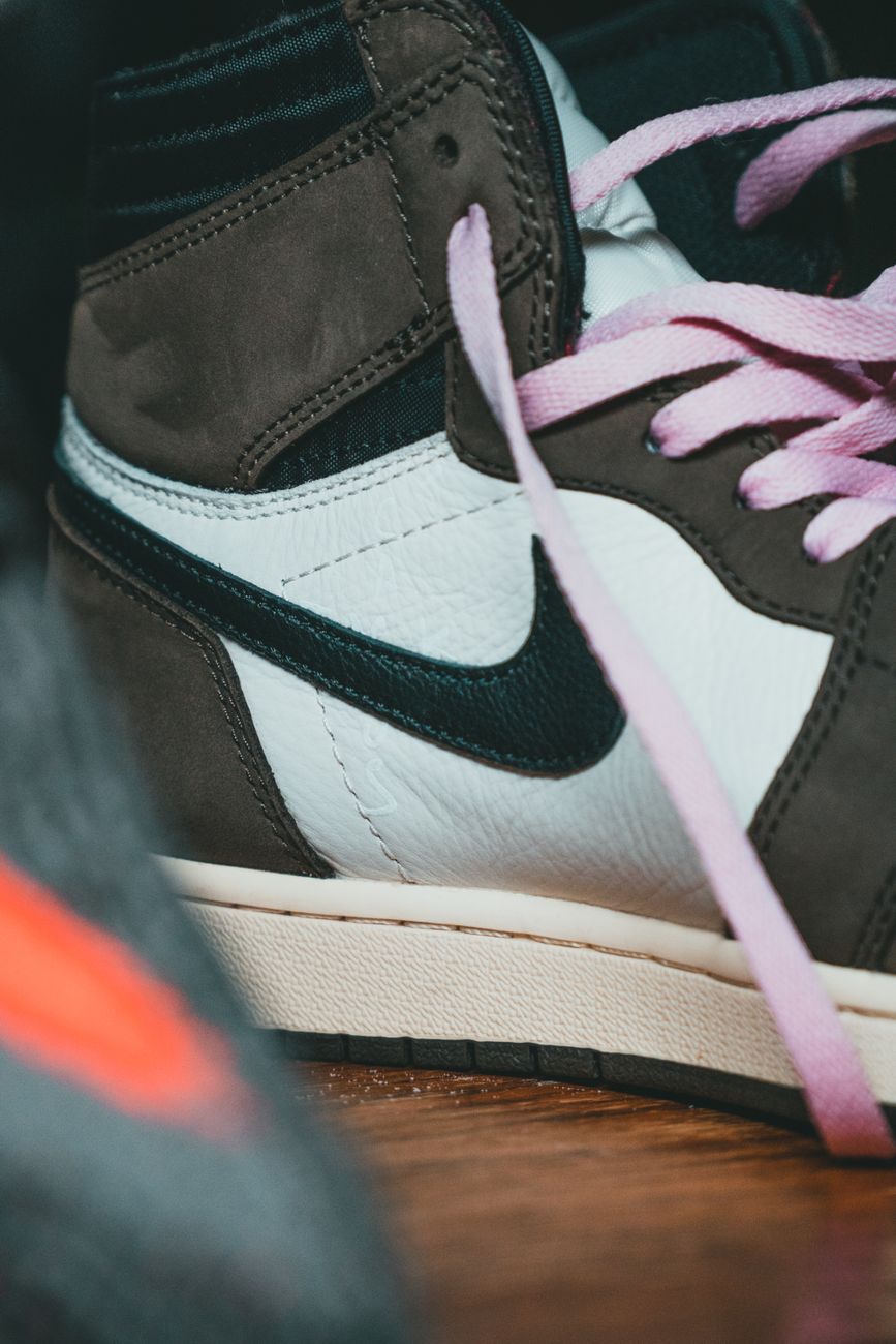 Detailed close-up of a stylish Nike sneaker showcasing unique pink laces and modern design.