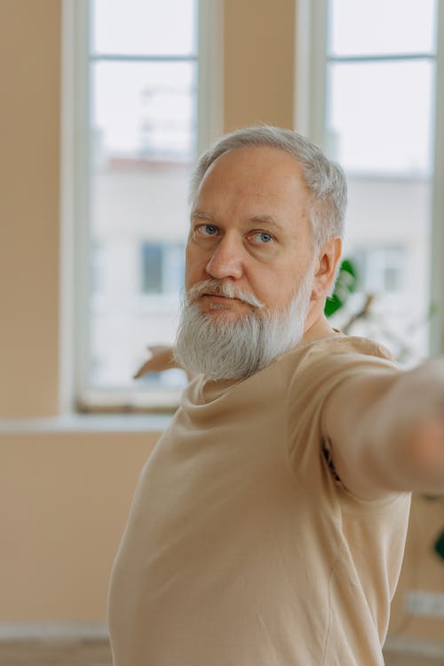 Man in Beige Shirt Doing a Yoga Pose