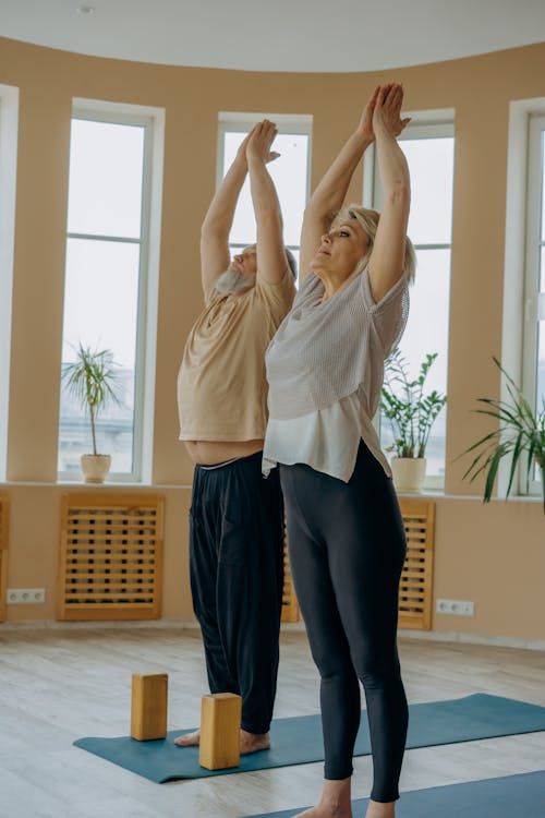 An Elderly Man and Woman Doing a Yoga