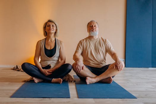 An elderly couple meditating in a yoga studio, promoting wellness and relaxation.