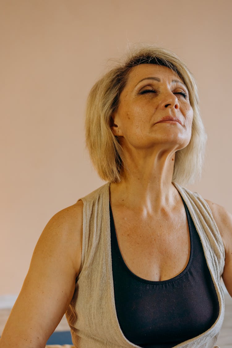 Elderly Woman In Black Tank Top Doing Deep Breathing