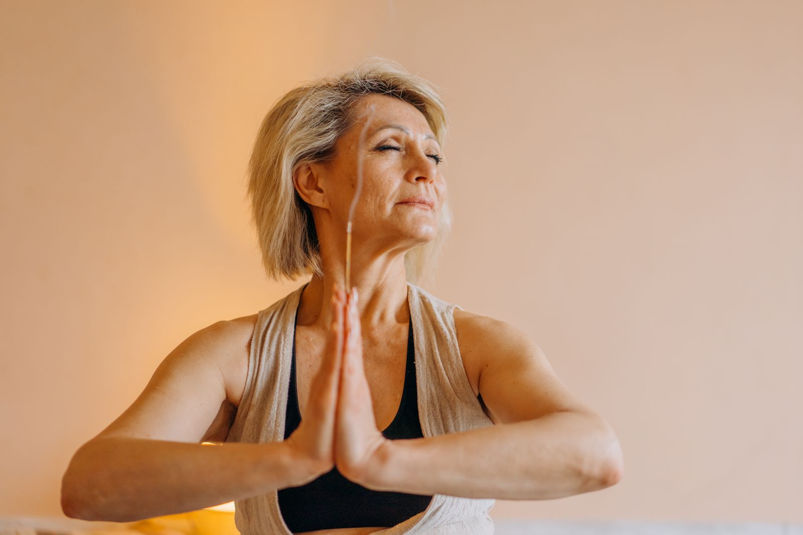 Senior woman meditating peacefully with eyes closed, practicing calming breathwork for heart health