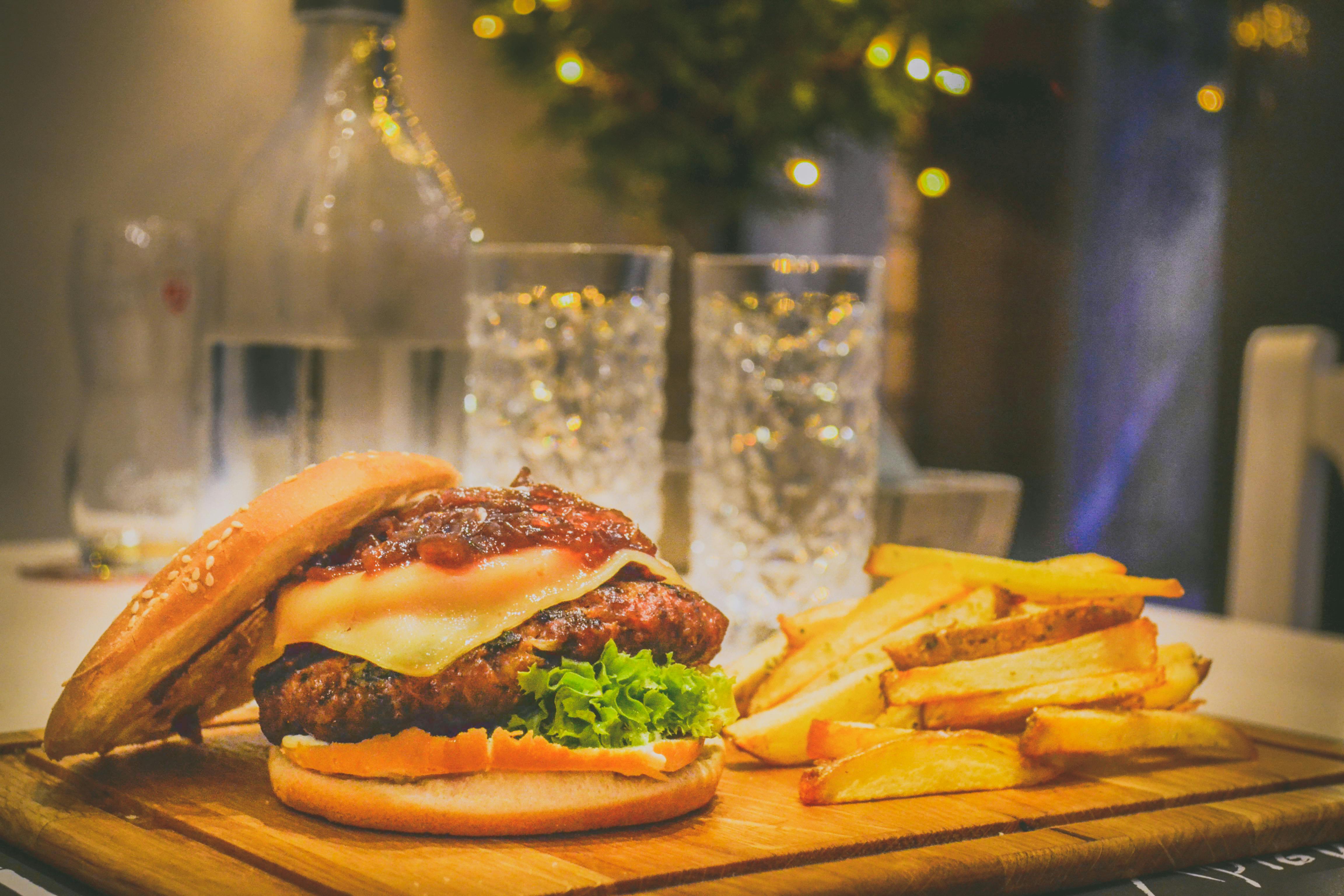 Premium Photo | A classic cheeseburger with french fries background design  wallpaper generated by AI