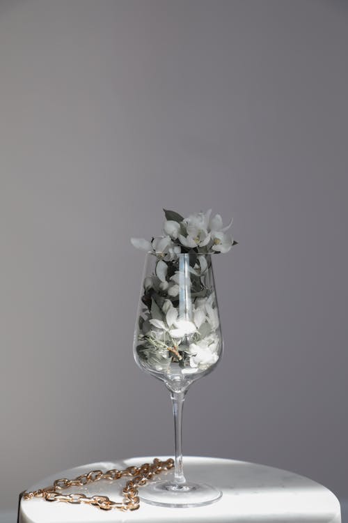 White Flowers in a Clear Glass on a Pedestal
