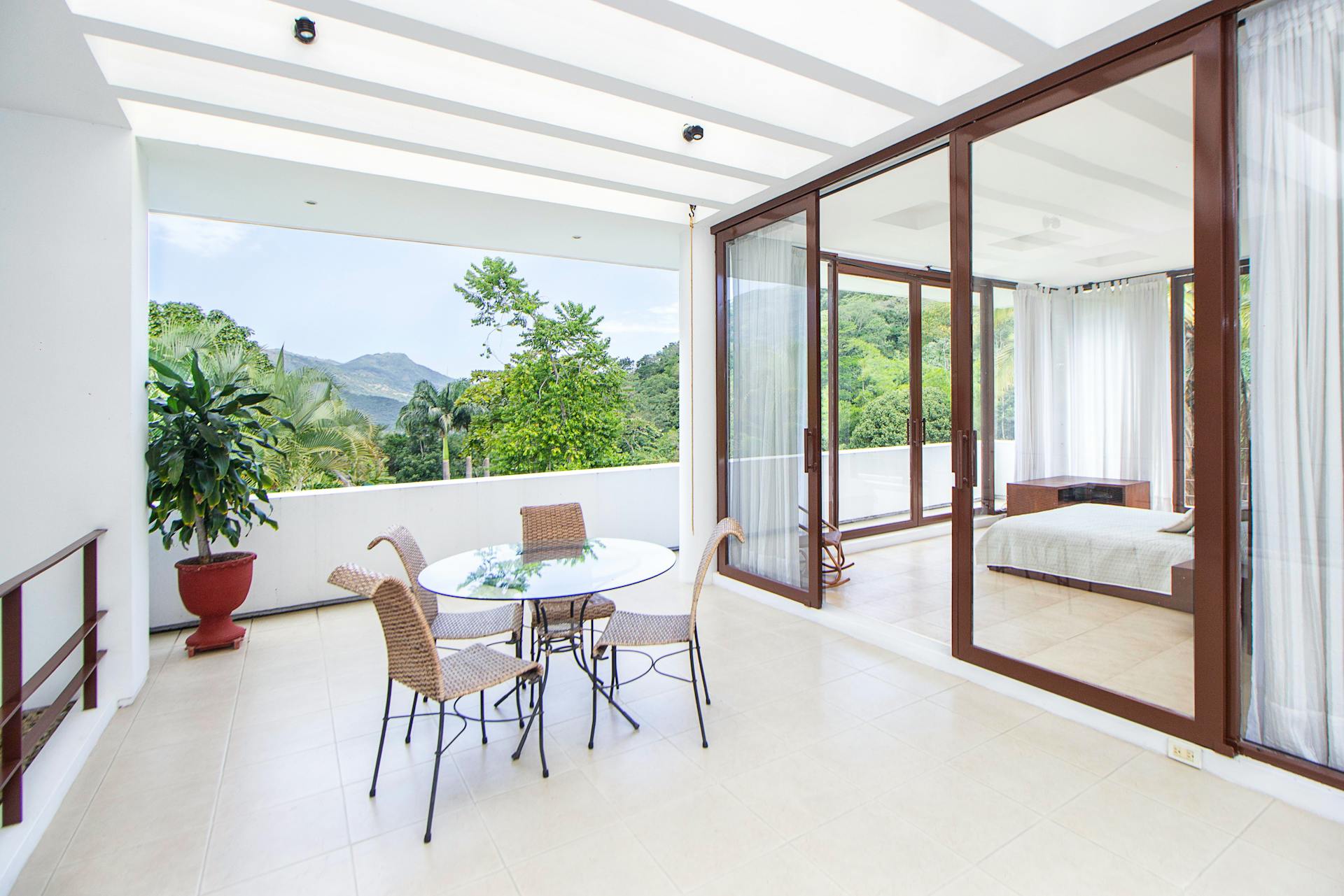 Stylish home interior featuring a modern balcony and an elegant bedroom with a scenic outdoor view.