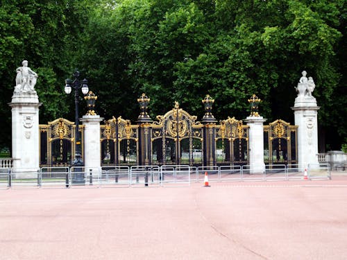 Free Black and Gold Gate Near the Green Trees Stock Photo