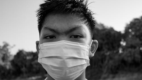 Free Asian male in mask looking at camera Stock Photo