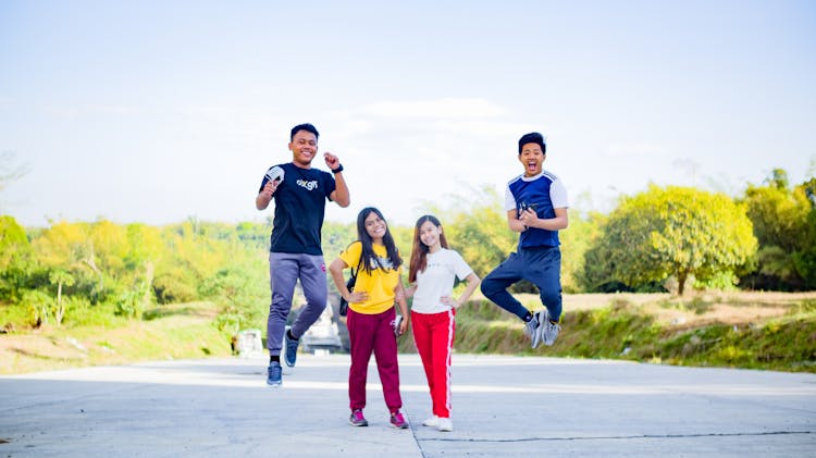 Happy Asian Friends Having Fun Together In Park