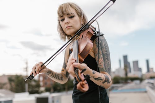 Free Tattooed Woman playing Violin 
 Stock Photo