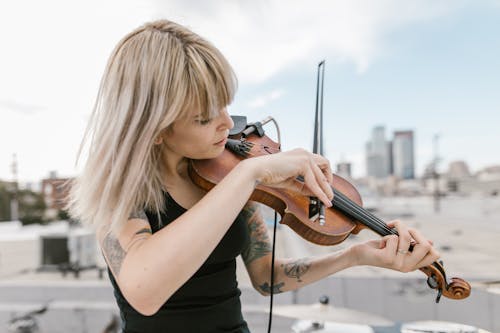 Woman in Black Tank Top Playing Violin