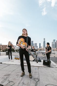 Band playing live music on a rooftop against a city skyline backdrop.