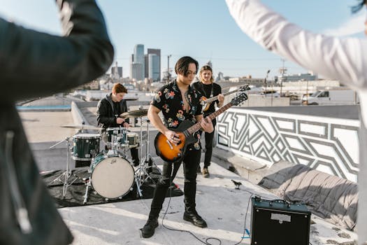 Outdoor music band performance on rooftop with city skyline in the background.