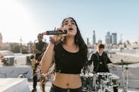 Woman in Black Crop Top Holding Microphone