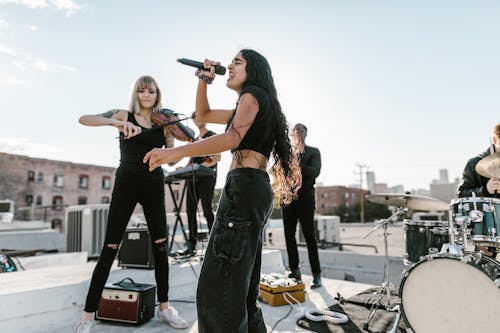 Free A Woman Violinist and Vocalist in a Rooftop Concert Stock Photo