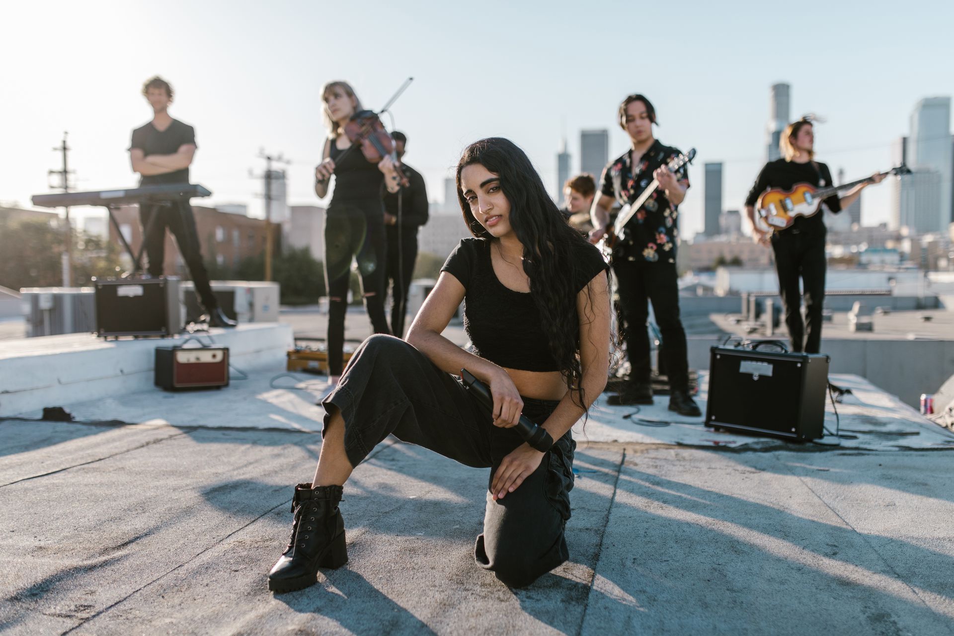 Indie band posing on a rooftop, showcasing a vibrant urban performance setting.