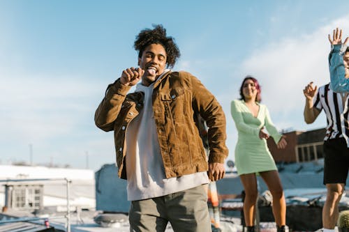 A Man in a Brown Jacket Dancing