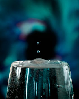 水滴悬浮在玻璃上方反射光线的艺术特写