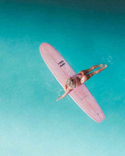 Woman on Pink Surf Board