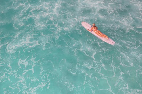Aerial Shot of a Woman in Bikini Surfing