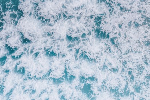 A dynamic top view of ocean waves and sea foam demonstrating nature's power and beauty., free online jigsaw puzzle on JigsawPuzzlesFreeOnline.org
