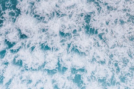 Aerial ocean wave by Jess Loiterton on Pexels