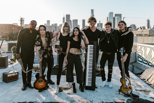 Young Band Posing Holding Music Instruments