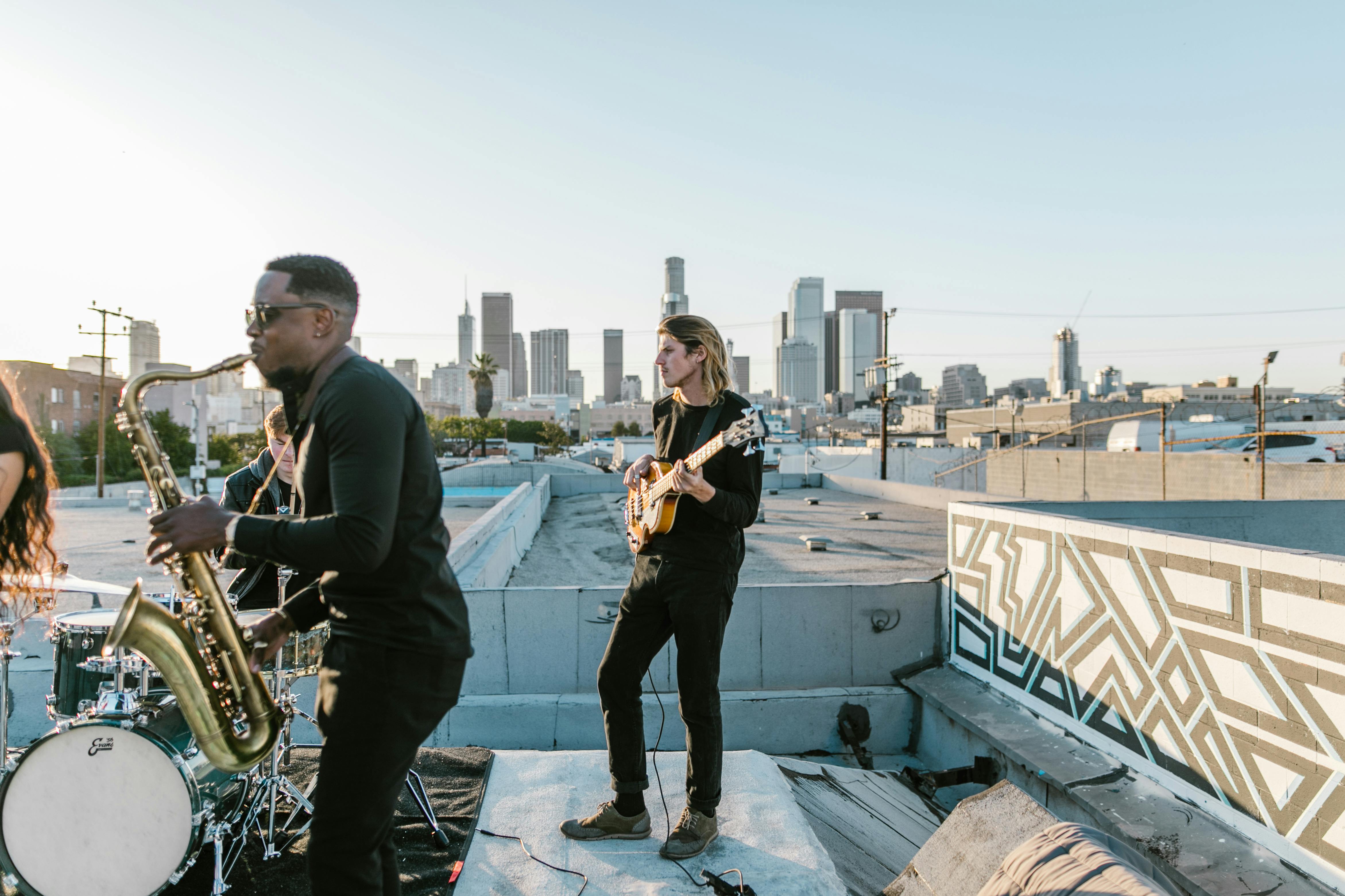 man in black jacket playing saxophone