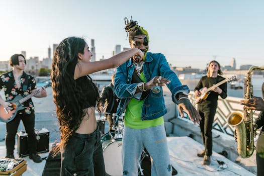 Energetic outdoor music performance with band, singers, and instruments on rooftop.