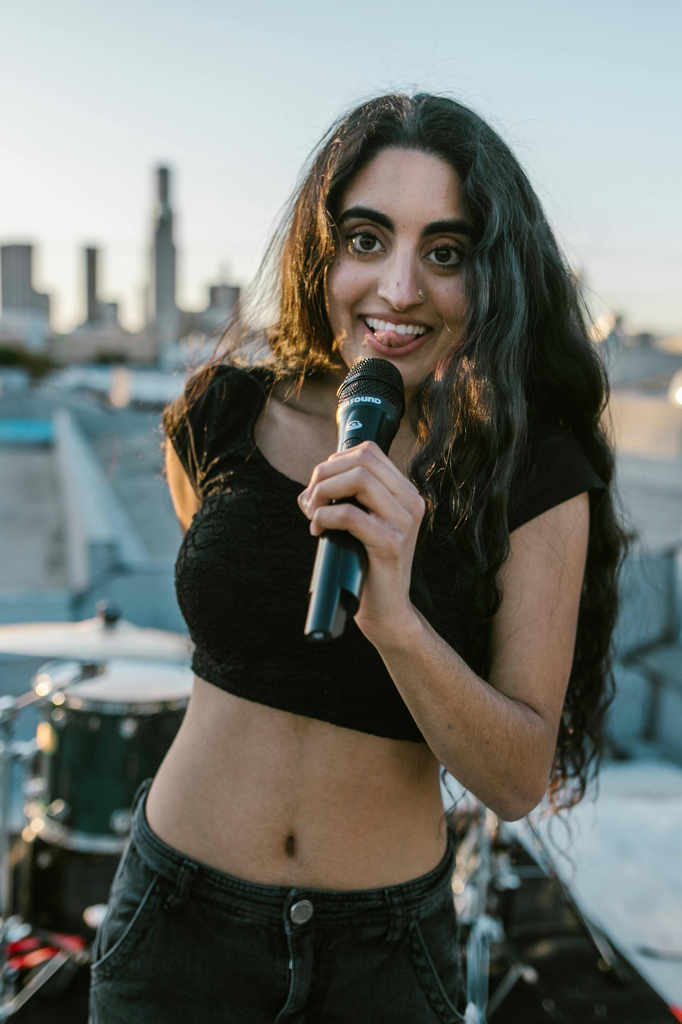 Woman in Black Crop Top Holding Microphone