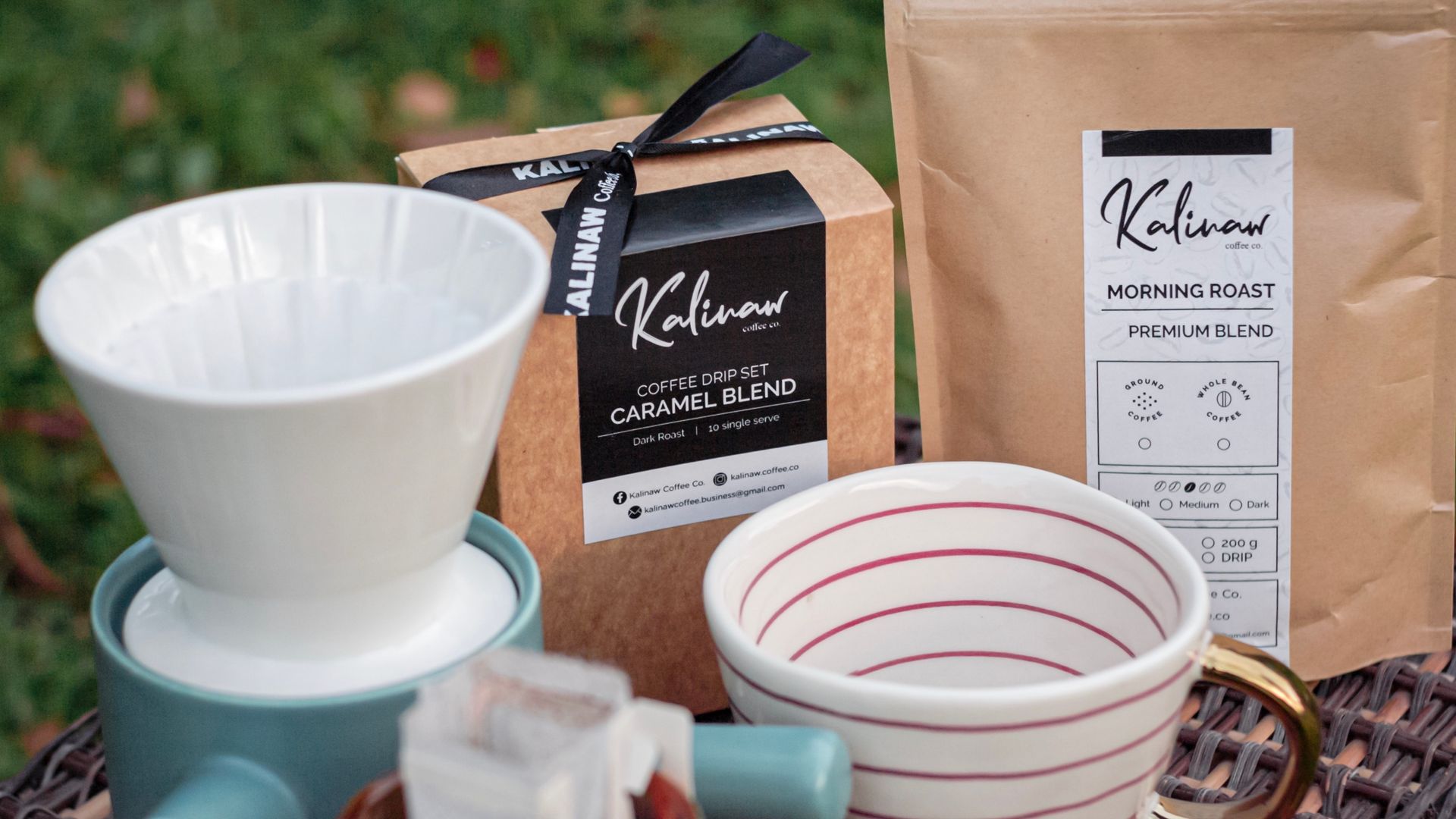 Close-up of a coffee drip set and packaging with Kalinaw branding outdoors.