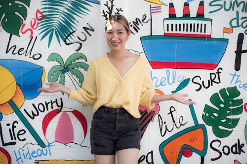 A Woman Standing in Front of Wall Painting