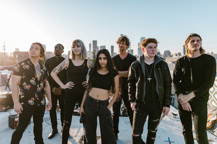 Music Band In Black Clothes Standing On The Rooftop