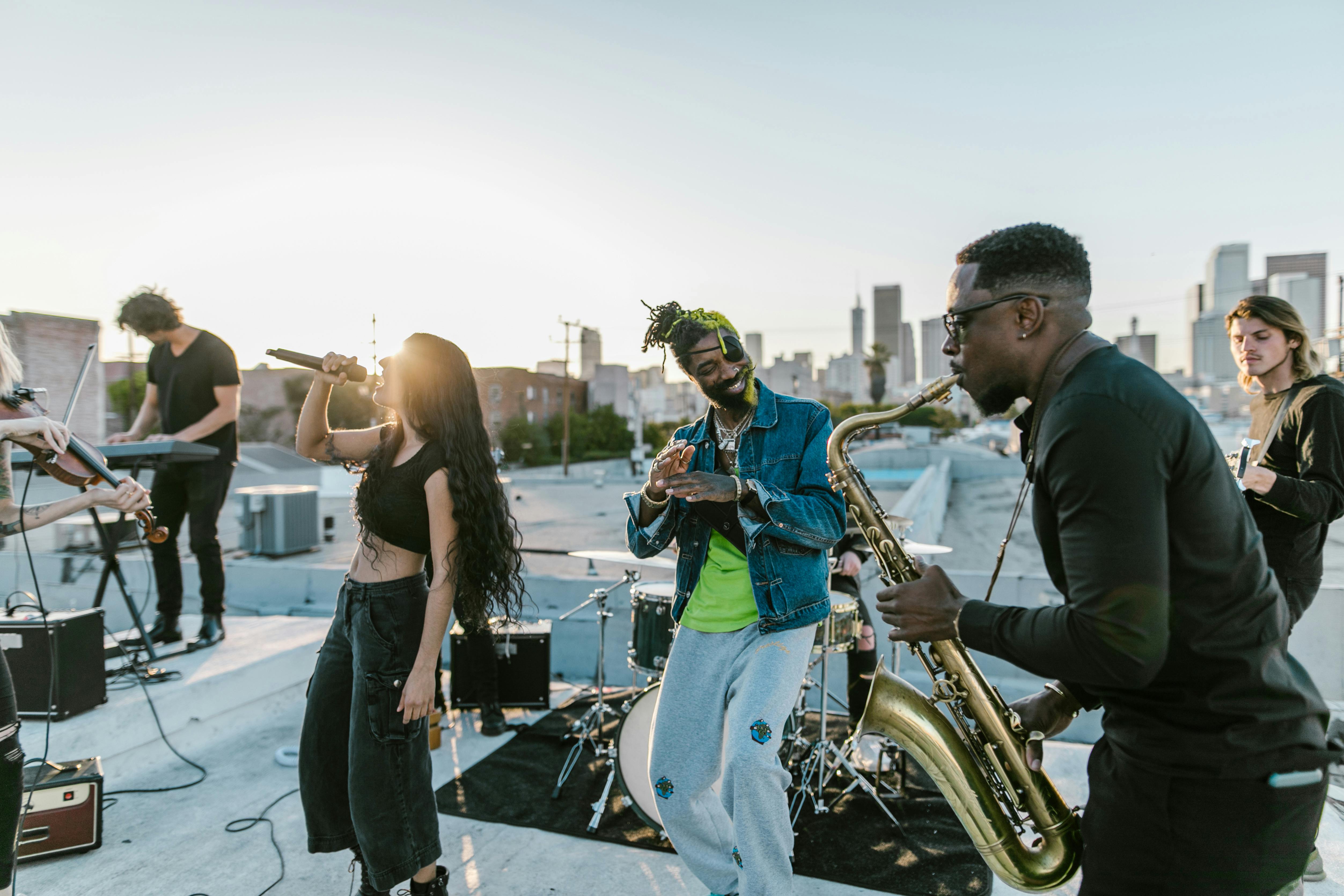 woman singing and man playing saxophone on the rooftop