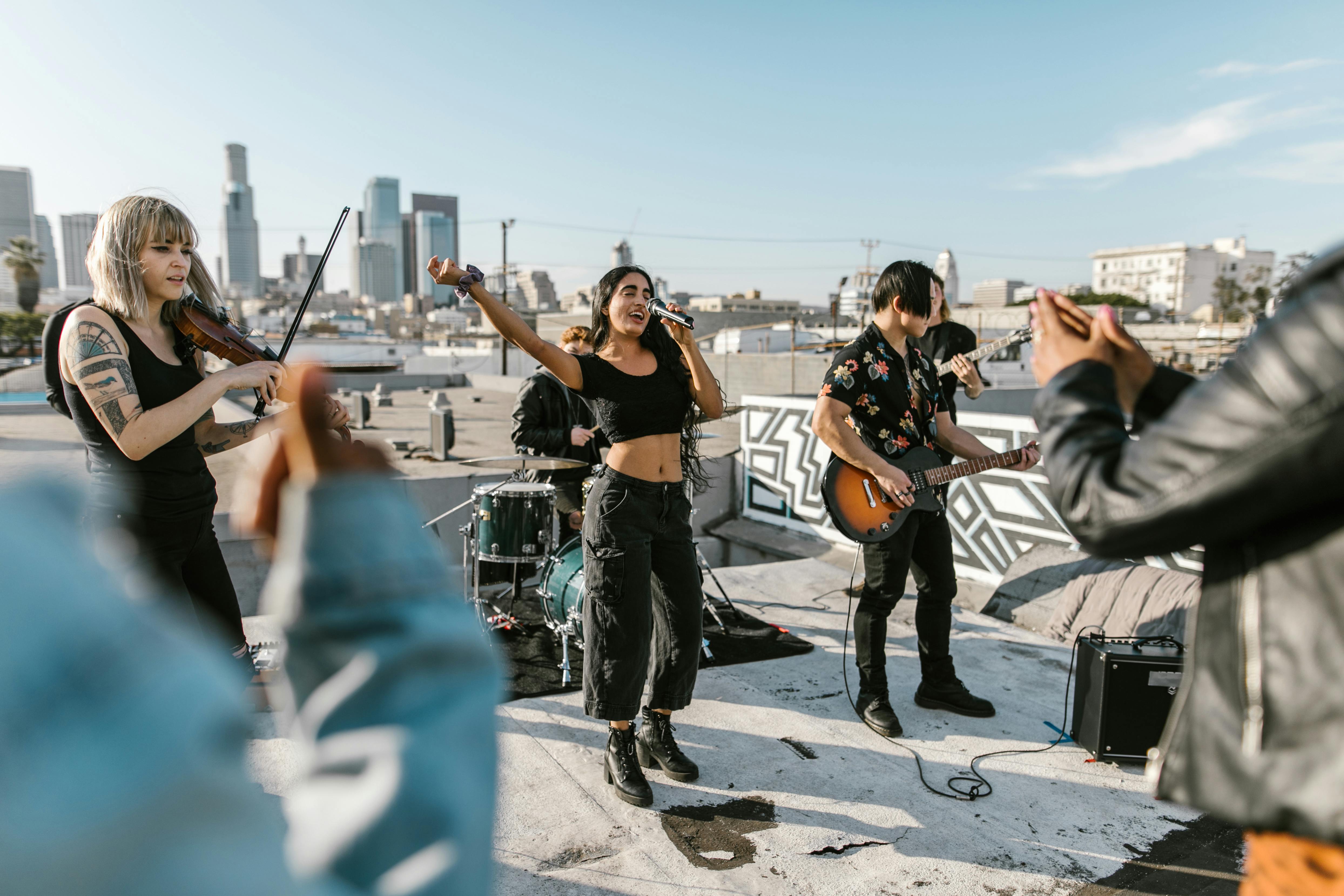 woman singing with music band on the rooftop