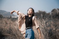 Woman in a Black Shirt Feeling the Wind