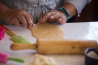 A Person Removing a Cut Floral Dough