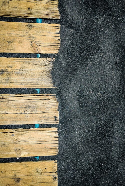 Overhead Shot of Wood Panels with Black Sand