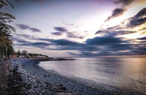 Безкоштовне стокове фото на тему «Захід сонця, океан, пляж»