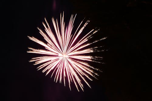 Free A White Fireworks Display on a Dark Night Sky Stock Photo
