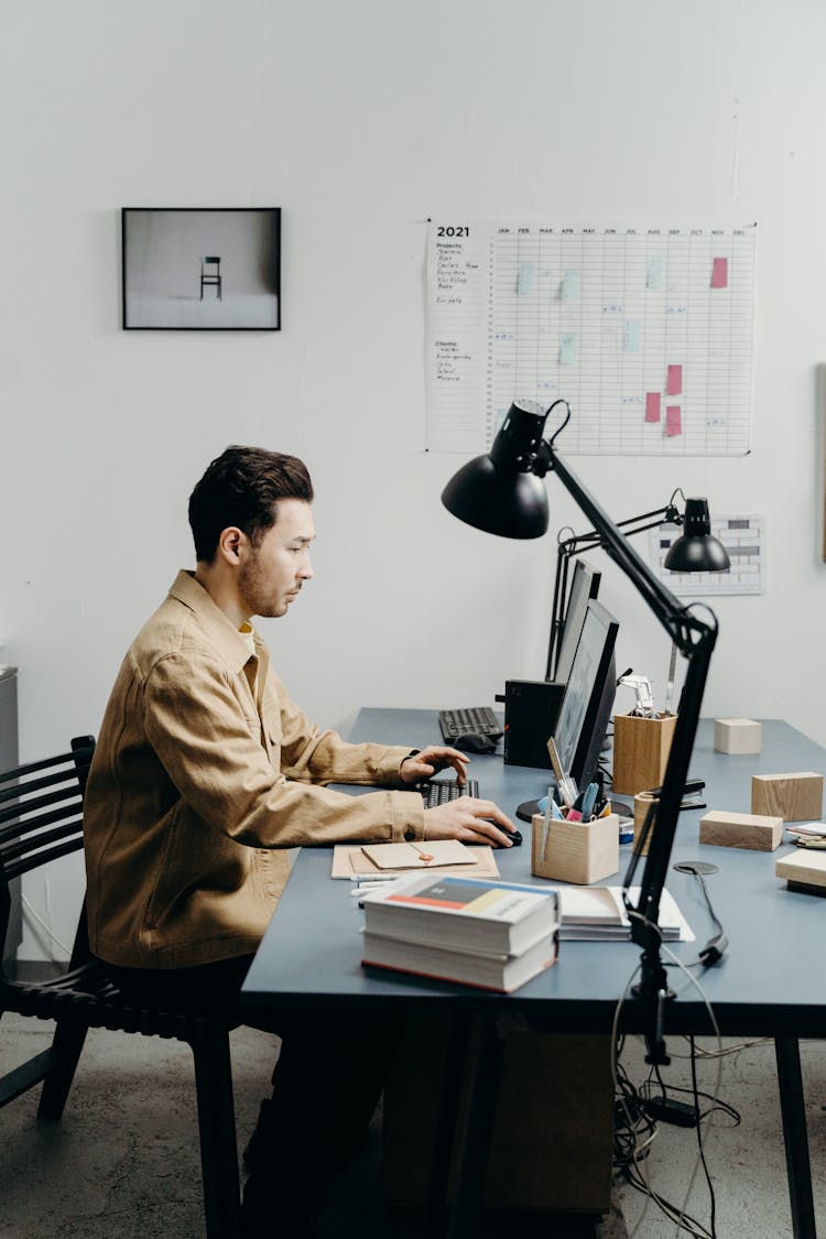 A Man Scrolling On The Computer