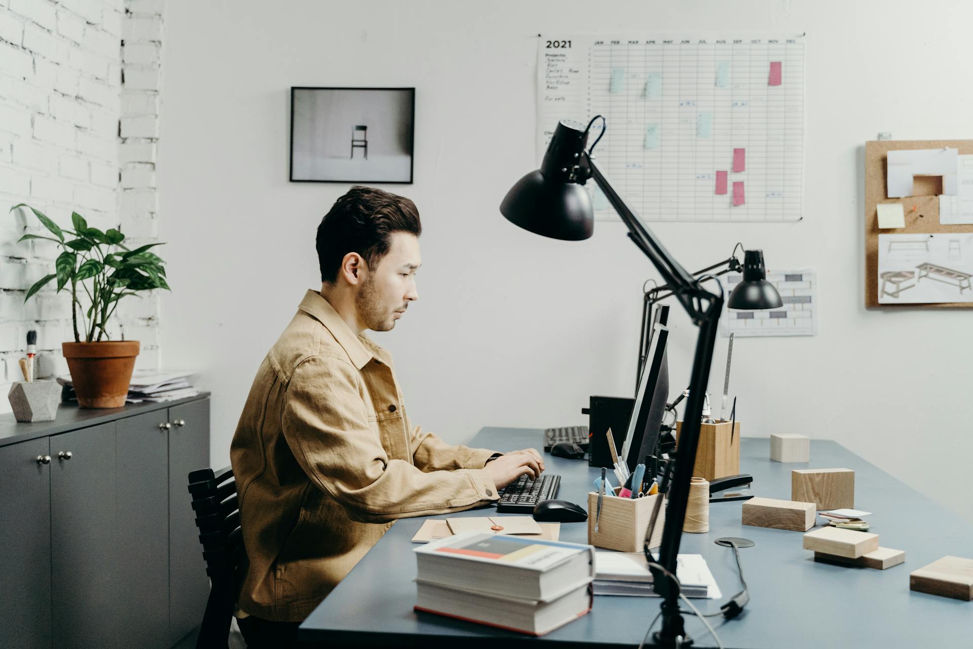 A Man Sitting at the Table While Using Computer