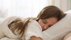 Woman in White Shirt Lying on Bed