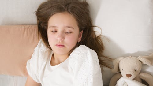 Free A Girl Sleeping on the Bed Stock Photo