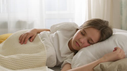 Free Girl Sleeping Under a Blanket Stock Photo