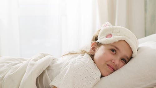 Free A Woman Lying on the Bed Stock Photo