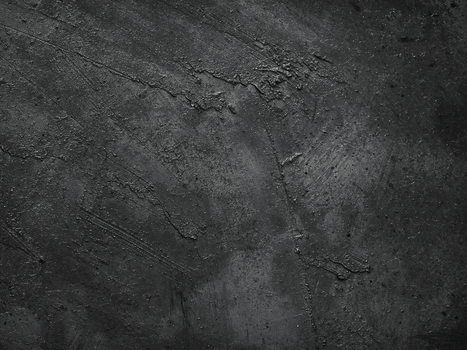 High-resolution image of a dark concrete wall with rough texture and subtle patterns.