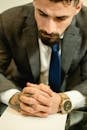 Man in Black Suit Jacket Wearing Gold Watch