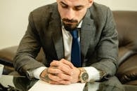 Man in Gray Suit Jacket Wearing Silver Round Analog Watch